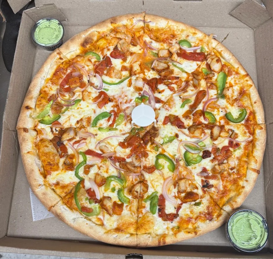 Whole specialty pizza with chicken, peppers and onions