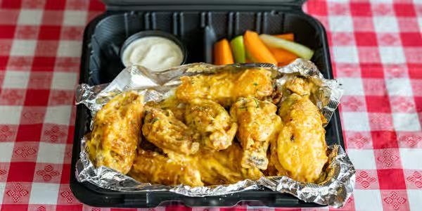 Crispy chicken wings from Quick Slice Pizza, served with dip, carrots and celery